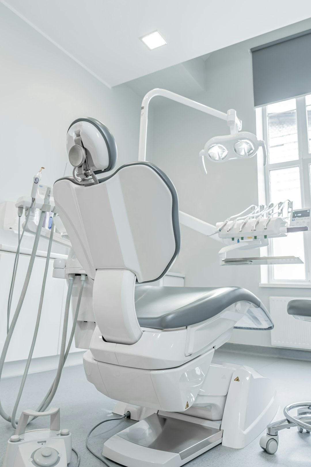 services-01 a-white-dental-chair-in-a-room-with-a-window-44jaetsvx2i