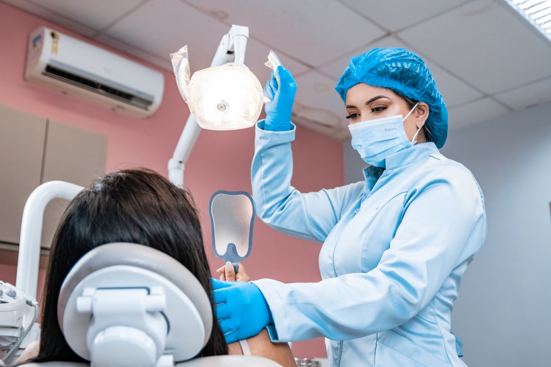 services-03 a-woman-getting-her-teeth-checked-by-a-dentist-z8biwpwv3zo